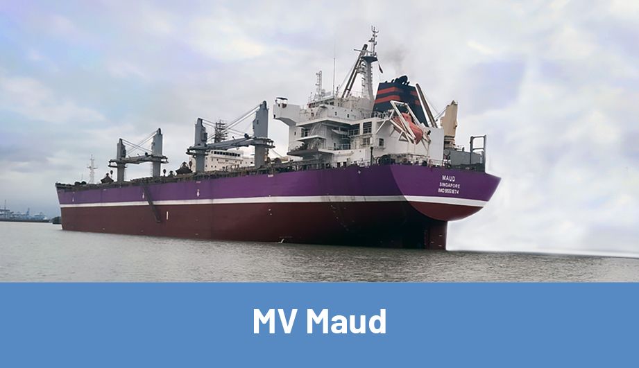 The Maud Motor Vessel after leaving the harbor, with buildings in the background