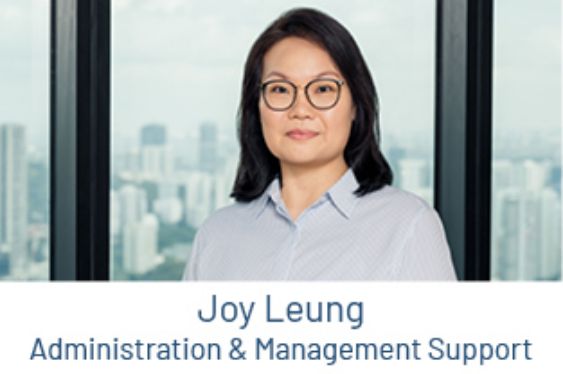Portrait of Joy Leung, Administration and Management Support, in front of a window